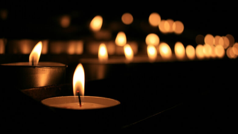 Lit candles in a dark area.